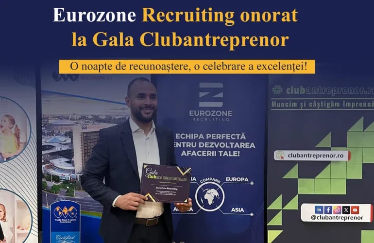 A colleague holding the Gala Clubantreprenor award certificate in front of the Eurozone and Clubantreprenor banners.